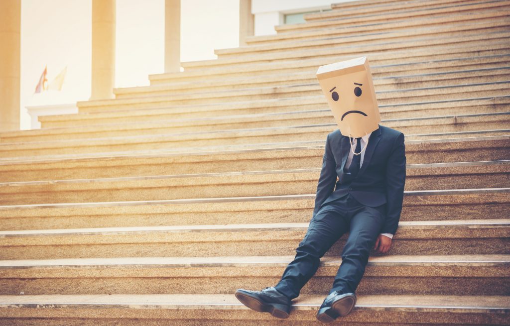 ©AdobeStock Businessman masked stress on the company stairs.